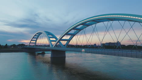 modern bridge at dusk over river