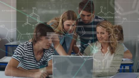 group of college students studying on a laptop