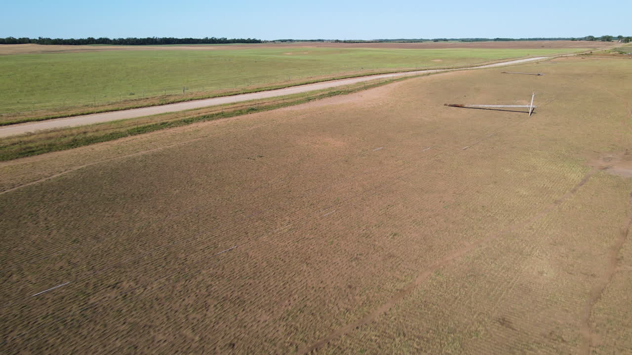 Aerial view of fallen power lines, tornado aftermath in Kansas, USA, sunny day