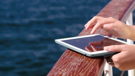 woman using pad while traveling by sea