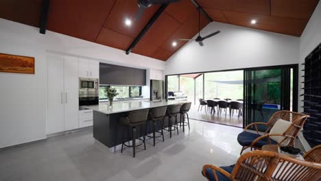 modern tropical villa kitchen with sleek cabinetry, large island, and natural lighting, ideal for contemporary tropical living