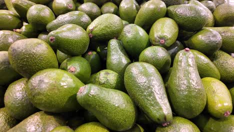 a pile of fresh green avocados