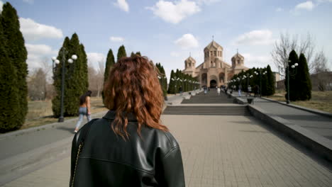 woman walking towards a church