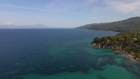 Descending-clip-over-an-exotic-beach-in-Vourvourou,-Haklidikin-in-northern-Greece-on-a-clear-summer-day