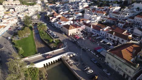 aerial orbit shot of ferragudo old town center in algarve, fishing village in south portugal