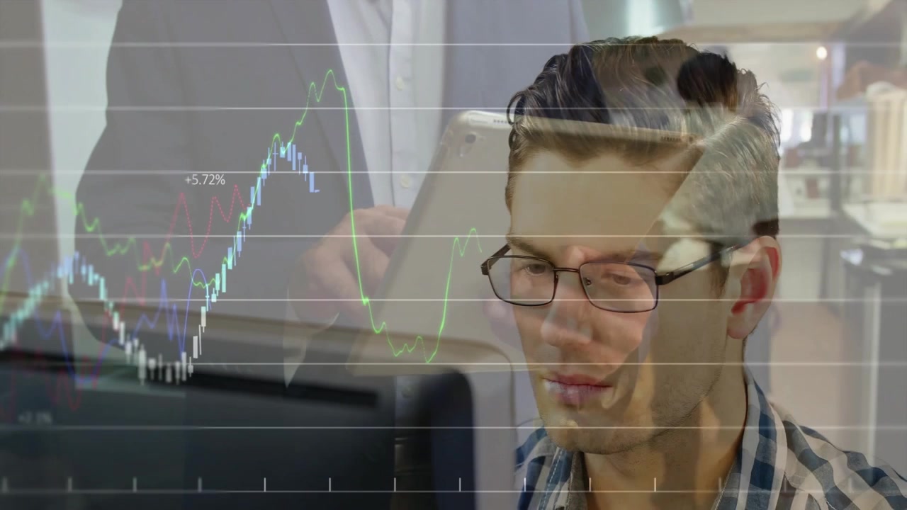 man analyzing market data on monitor in office, showing animated financial line charts overlaying