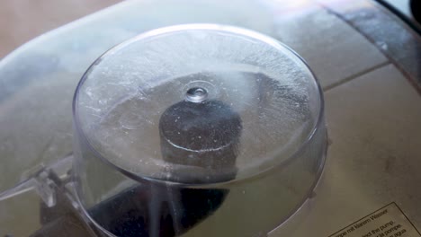 a close up shot through the control glass where the dirty water passes into the deep cleaning machine