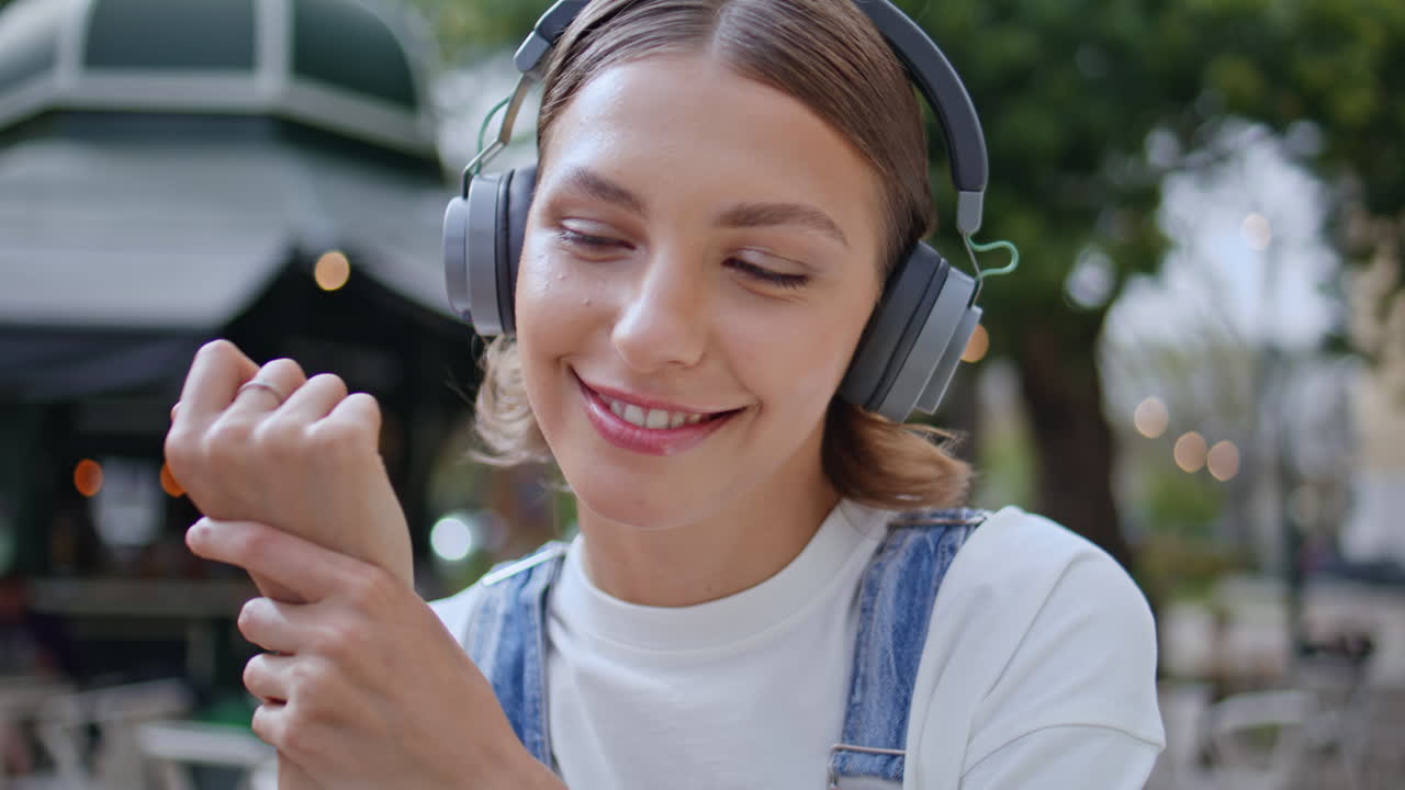 Headphones student talking videocall sitting park cafeteria closeup