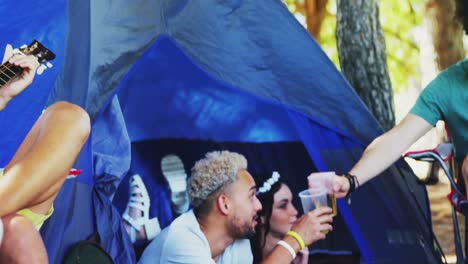 Friends-having-glass-of-beer-in-tent-at-music-festival-4k