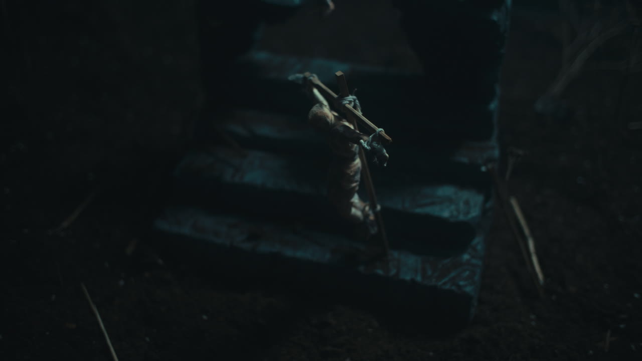 Miniature mummified dolls hanging on the gallows at night