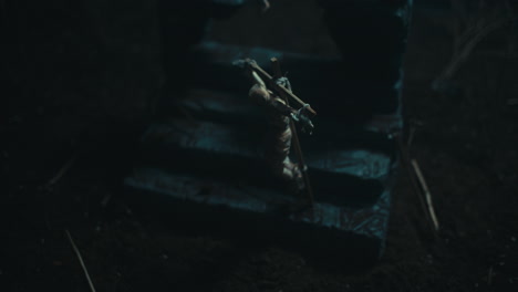 miniature mummified dolls hanging on the gallows at night