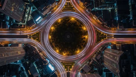aerial night view of a city roundabout with long exposure light trails