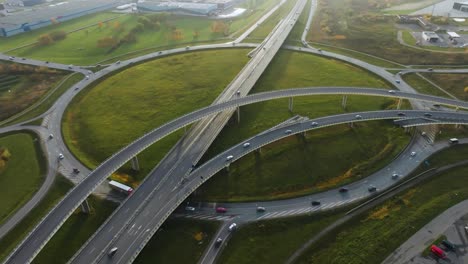 an aerial view a large roundabout on the outskirts of the city with several bridges for cars and trucks no traffic