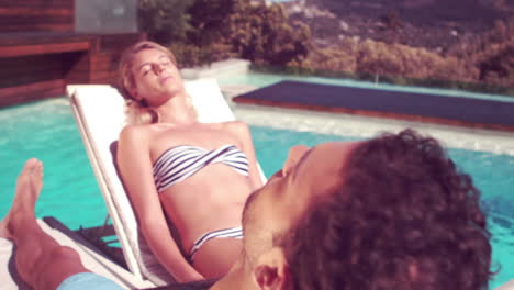 attractive couple relaxing by the pool