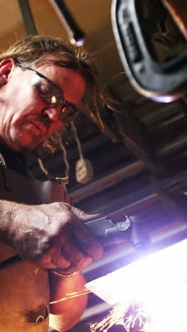 welder using welding torch