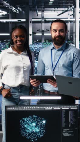 vertical video portrait of smiling engineers in server room using ai