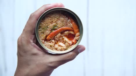 hand holding a can of spicy tuna