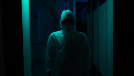 person in protective gear in a dark corridor