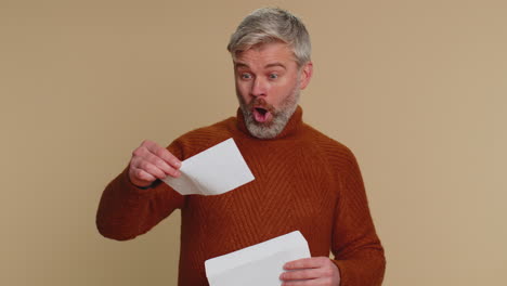 senior middle-aged old man open envelope letter, great news, celebrate, monetary award, invitation