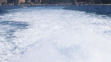 boat creating wake in sorrento, italy