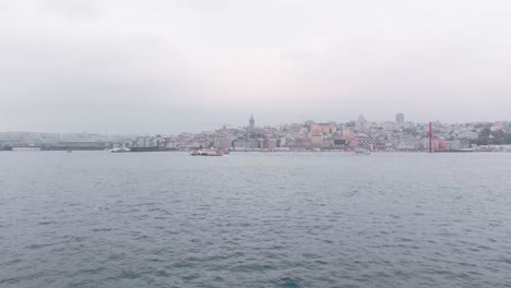 Flying-over-the-golden-horn-river-towards-the-northern-part-of-the-European-side-of-Istanbul,-Turkey