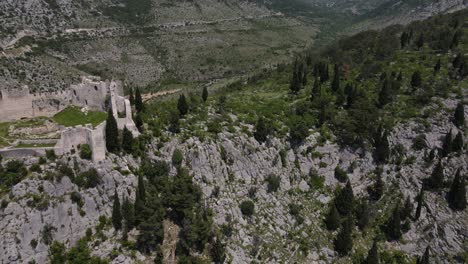 an aerial view shows the blagaj fortress sitting atop karst hill in mostar, bosnia, lodge viewed from the castle at the top of the mountain