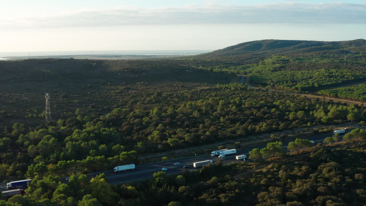 Highway with traffic cars and trucks aerial shot garrigue along the sea