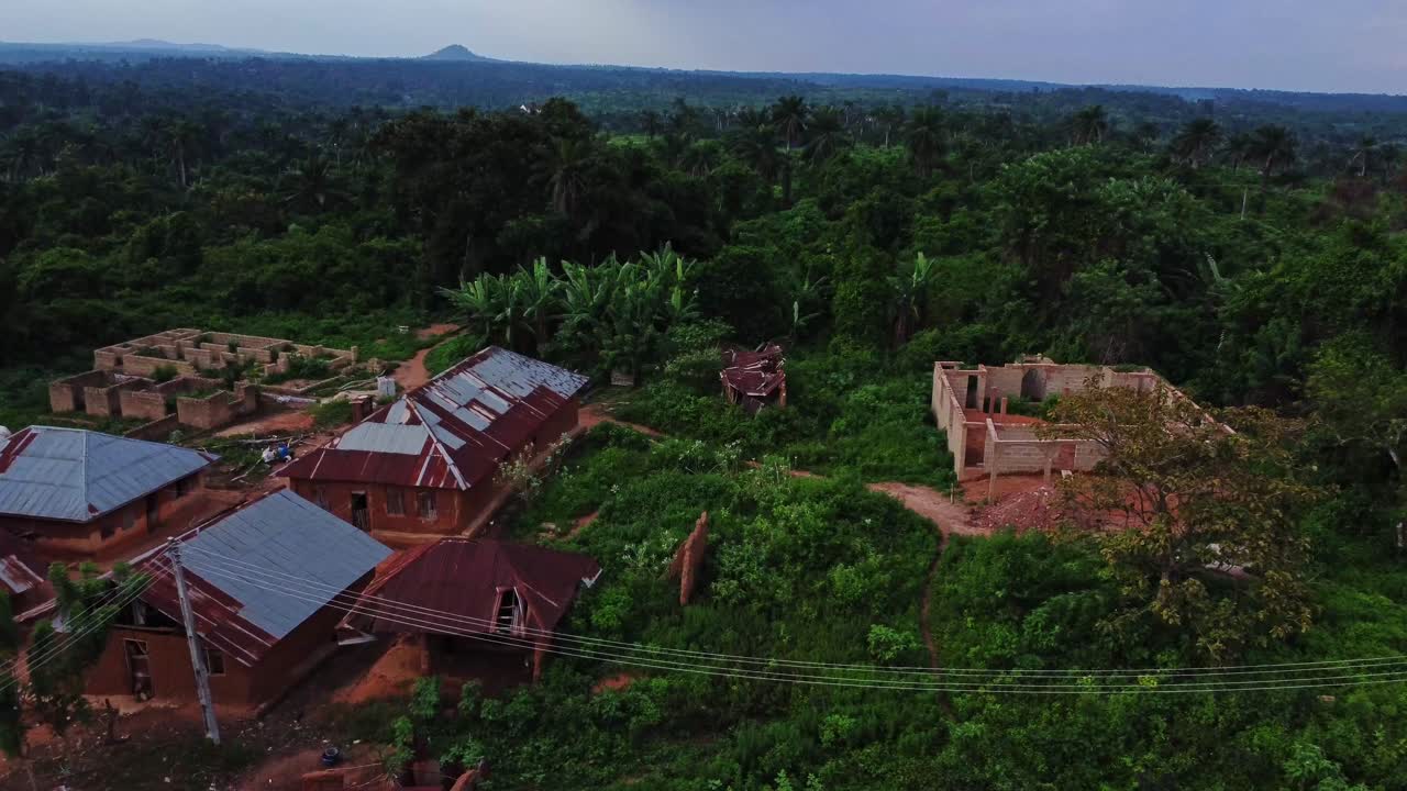 Beautiful establishing aerial of a remote ancient village in the countryside of Nigeria, Africa