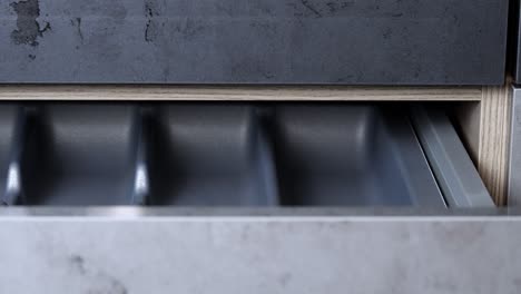 Woman-with-painted-fingernails-opens-and-closes-cabinet-drawer