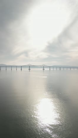 from above, the richmond-san mateo bridge arcs gracefully over the bay.