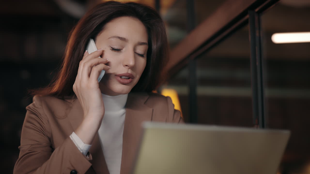 Businesswoman on a phone call using a laptop