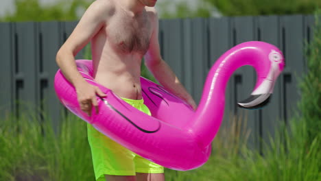 man with inflatable flamingo