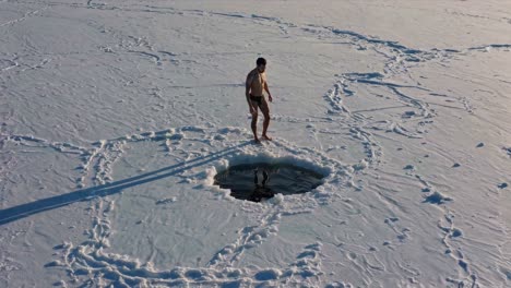man ice swimming in winter