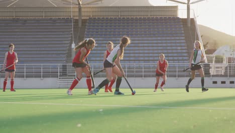 Female-hockey-players-playing-on-the-field