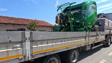 truck carrying machinery through residential area in piedmont