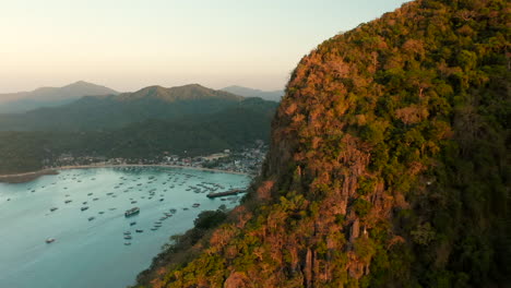 Aerial-revealing-the-harbour-of-El-Nido-with-sunset,-Palawan,-Philippines