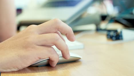 man hand working with wireless mouse on a desk