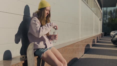 a skater girl waits for someone to sit down and drink water