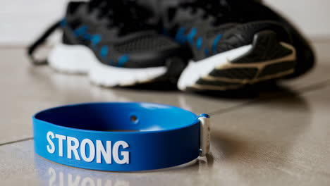 motivational wristband with running shoes