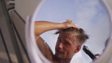 man-is-cutting-his-own-hair-with-a-trimmer