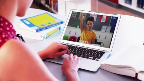 Caucasian-girl-using-laptop-while-having-a-video-call-with-caucasian-boy-at-home