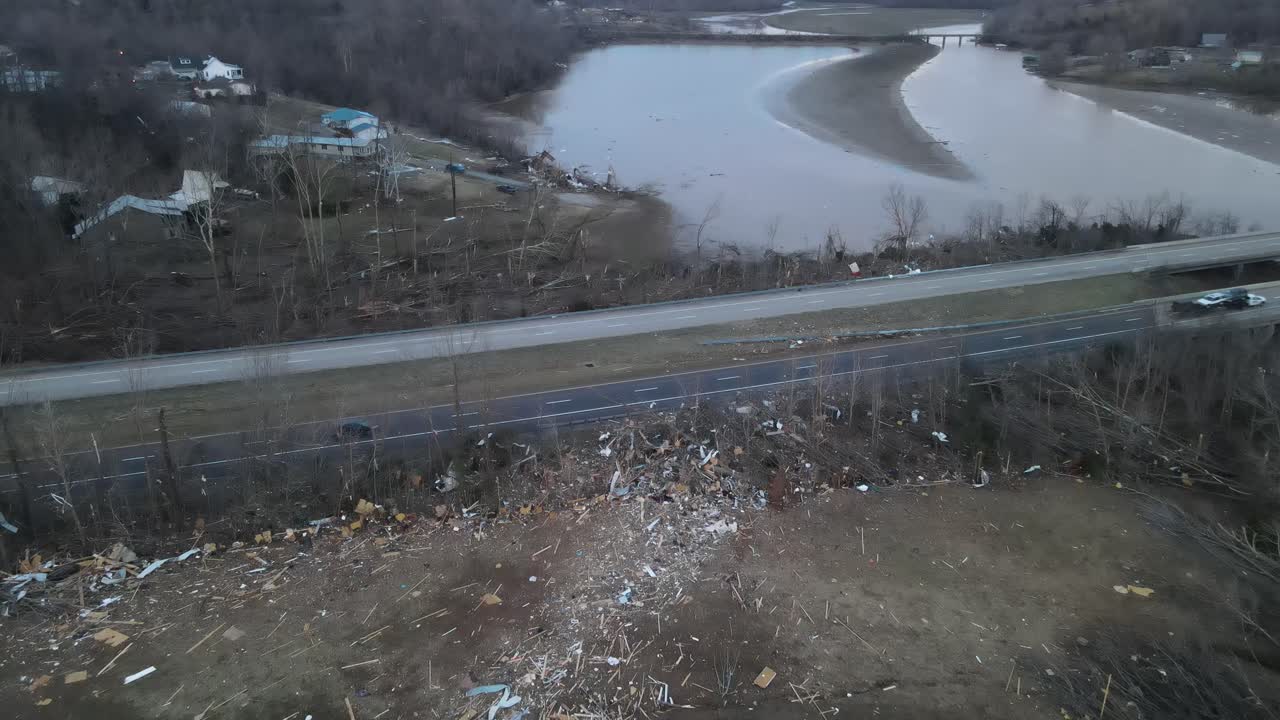 Aerial close-up of a destroyed home and debris trail from a tornado on Lake Barkley, Kentucky. 2021-12-10. Dramatic debris trail visible to highway