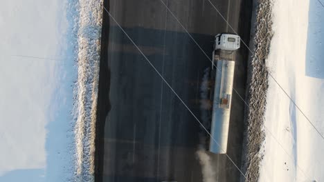 Truck-Crossing-Snow-Covered-Asphalt