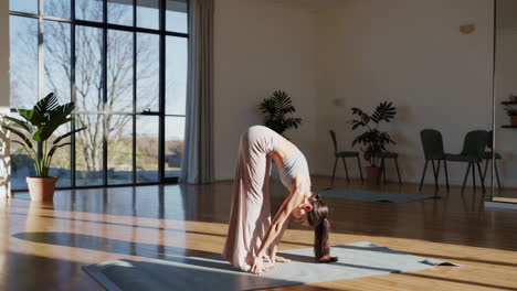 woman practicing yoga forward bend