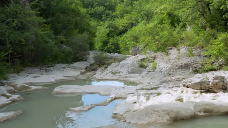 Rocky-mountain-cascade-falls-in-remote-Croatian-hillside,-summer-aerial-4K-view