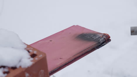 damaged wooden plank in snow