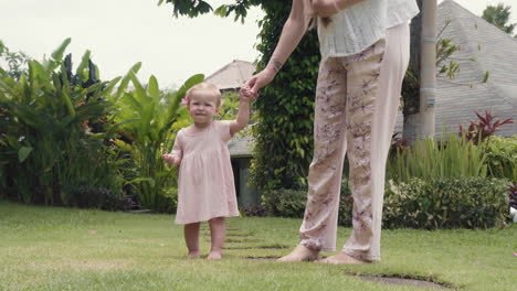 woman walking with baby in garden