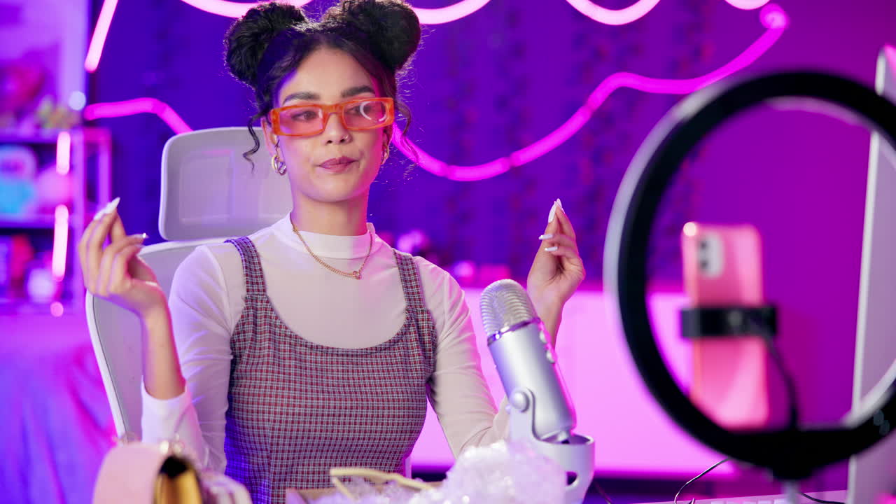 Young woman vlogging with ring light and microphone