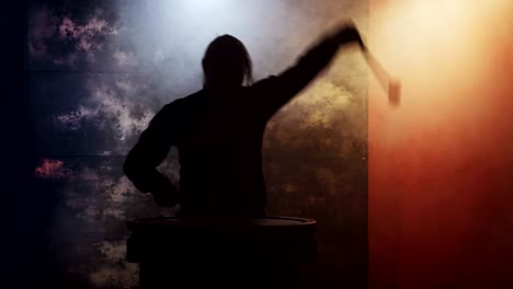 silhouette of man drummer. he is playing drum music