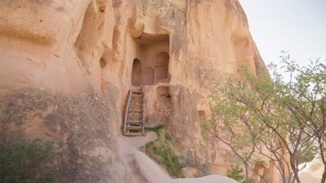 Wood-ladder-entrance-to-manmade-rock-cave-dwelling-Cappadocia-landscape